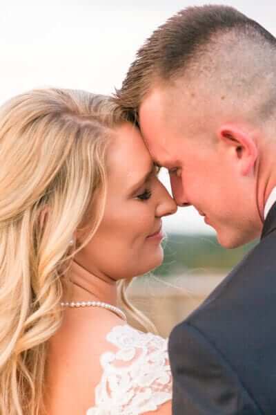 WV Weddings couple, bride and groom, in field. Photographed by Katelyn Workman Photography.